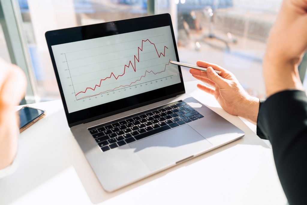 Office workers watching company growth chart on laptop thanks to the contact center features.